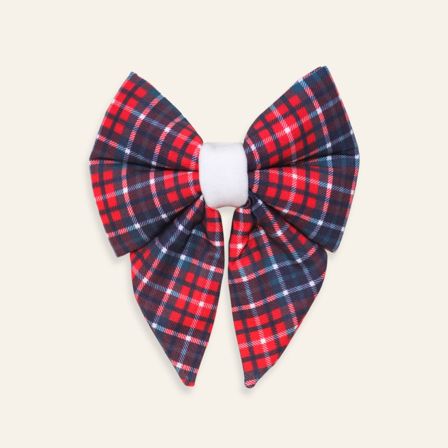 Handmade red and navy tartan plaid dog sailor bow made from soft cotton, over-the-collar Christmas bow for dogs and puppies with a classic holiday design.