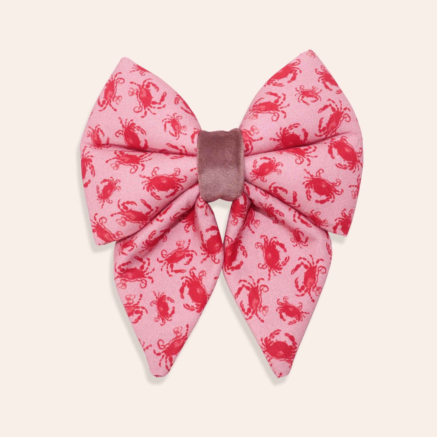Pink coral dog bow with red crab pattern on a white background