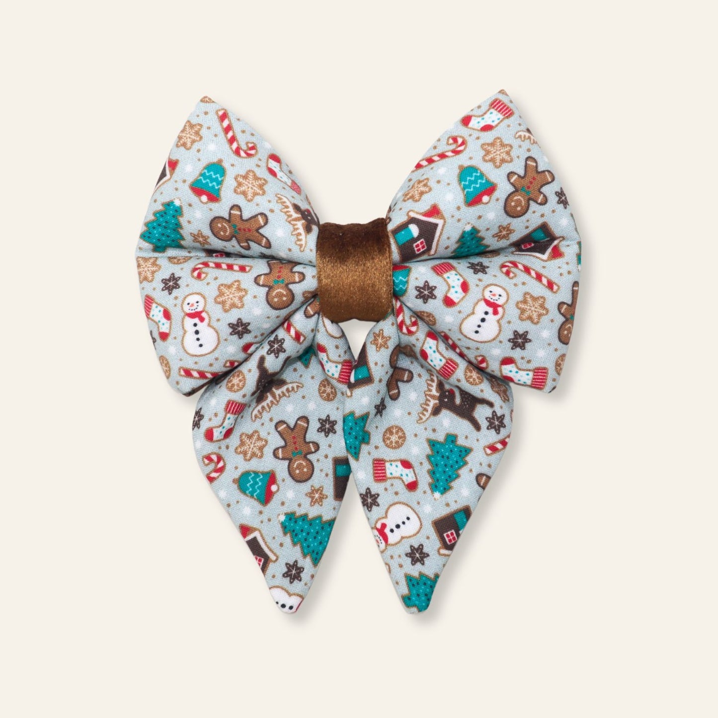 Handmade Christmas dog sailor bow featuring gingerbread houses, Christmas trees, candy canes, cookies, and festive holiday treats, designed to slide over a dog collar for a festive holiday look.