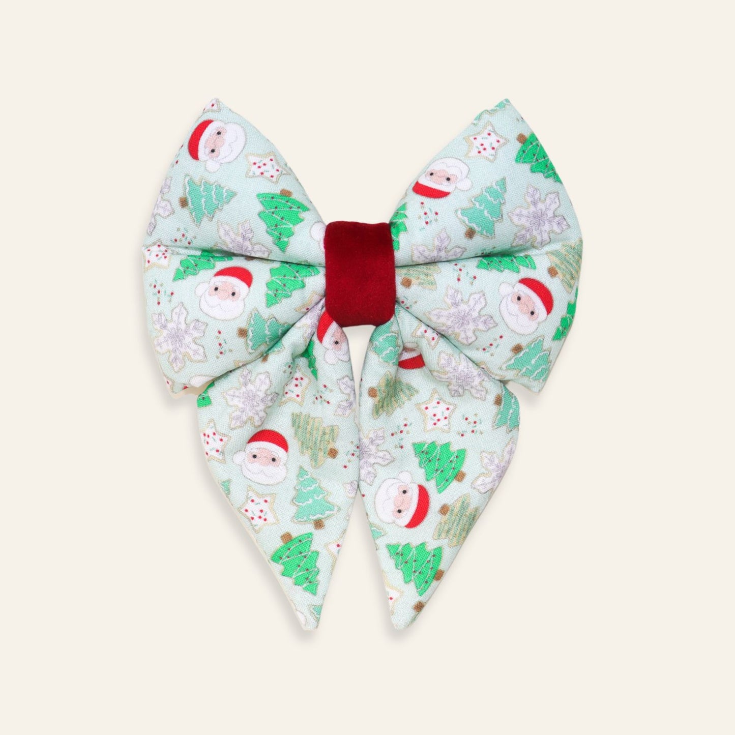 Handmade Christmas dog sailor bow featuring Santa Claus, Christmas trees, snowflakes, and holiday cookies on soft cotton with a red velvet center, over-the-collar accessory for dogs and puppies.