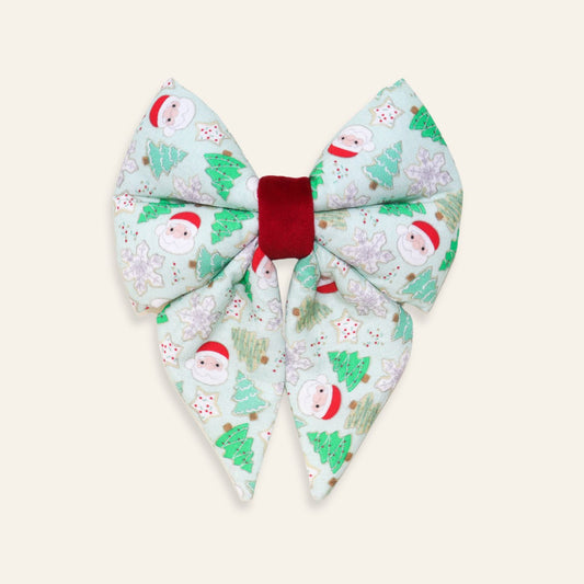 Handmade Christmas dog sailor bow featuring Santa Claus, Christmas trees, snowflakes, and holiday cookies on soft cotton with a red velvet center, over-the-collar accessory for dogs and puppies.