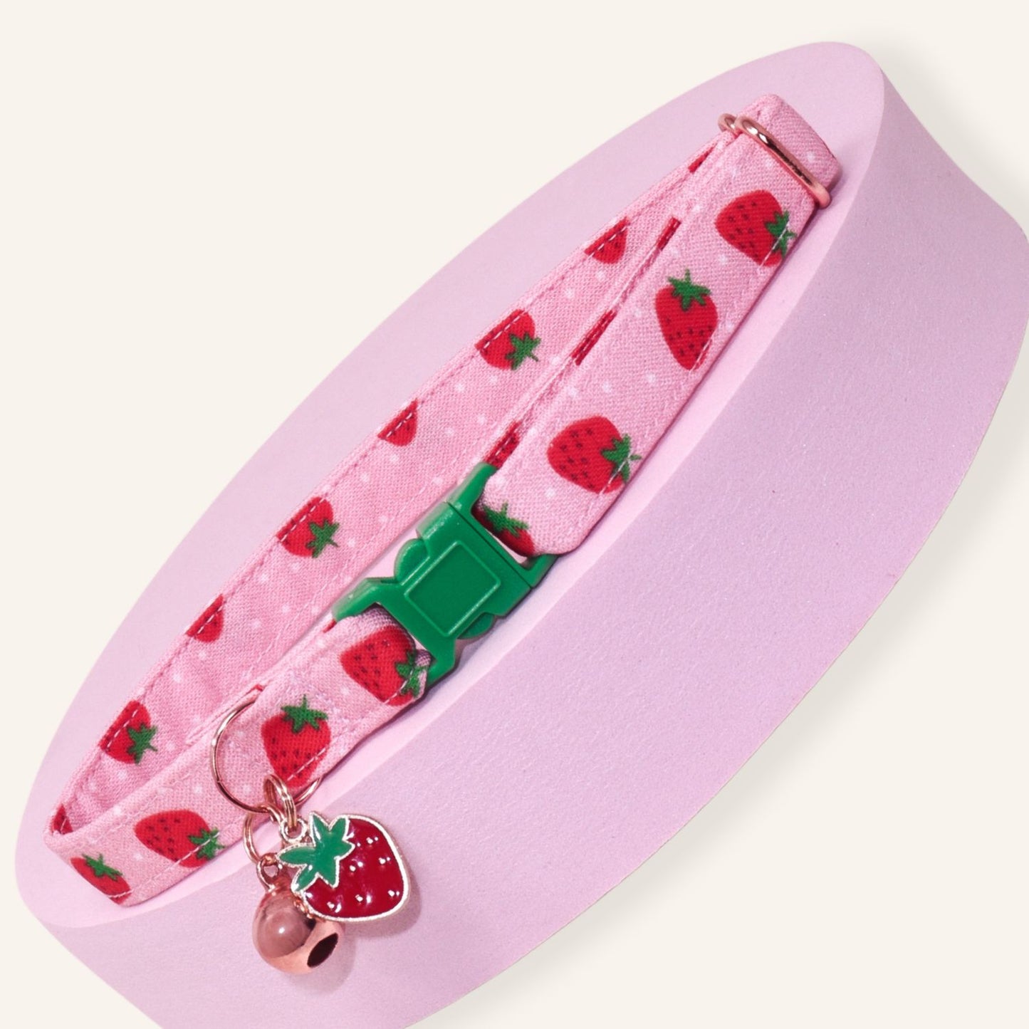 Handmade pink strawberry breakaway cat collar with adjustable safety buckle, rose gold bell, and strawberry charm for kittens and cats.