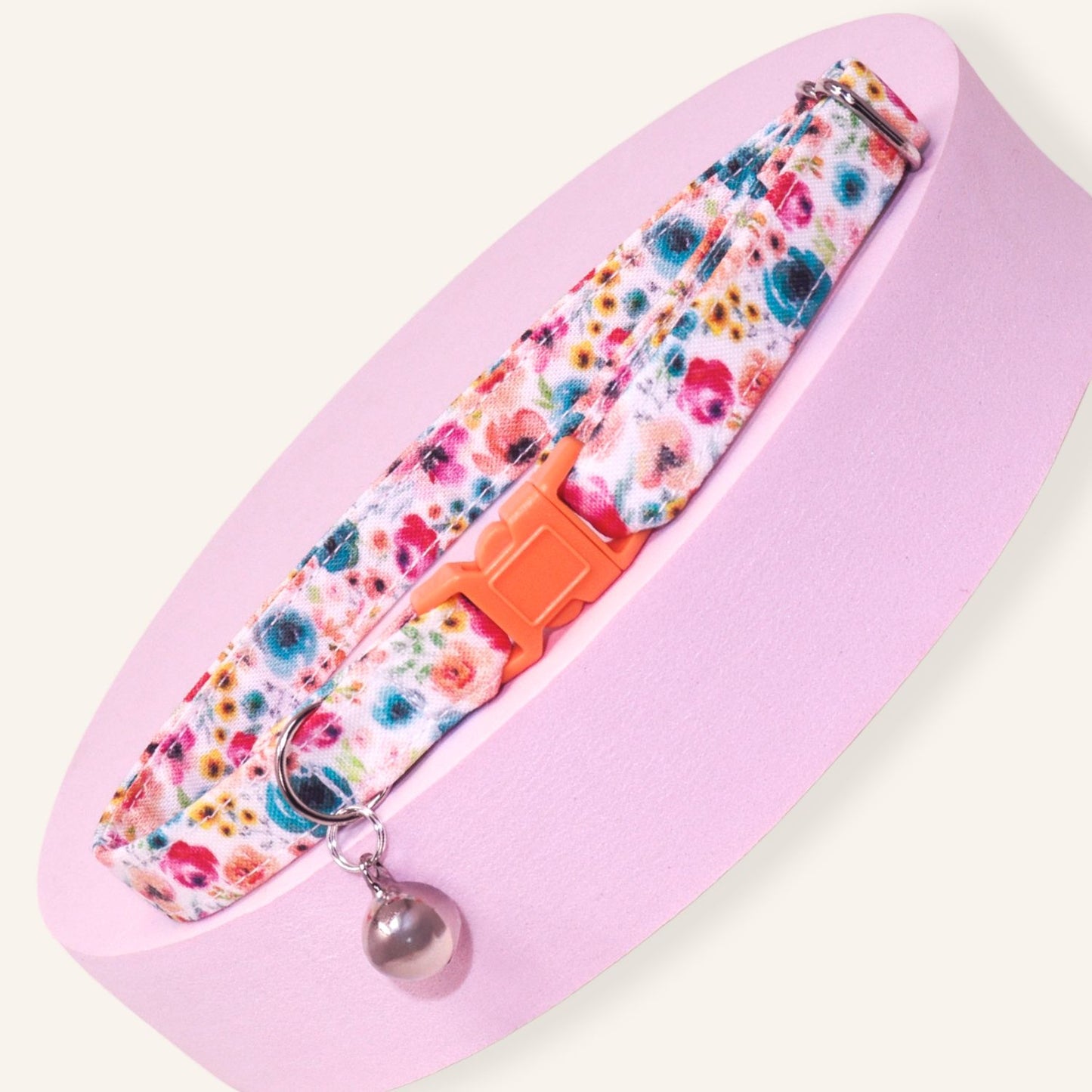 Handmade wildflower breakaway cat collar featuring colorful floral prints, coral safety buckle, silver bell, and adjustable cotton design for kittens and adult cats.
