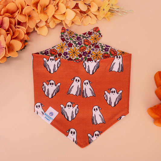 Golden Poppy reversible dog bandana with floral print on one side and orange ghost pattern on the other, handmade snap-on bandana for fall and Halloween pets