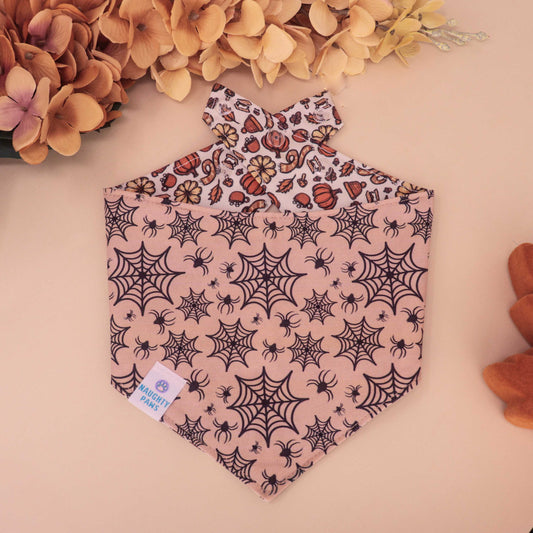 Harvest Market reversible dog bandana with pumpkins and florals on one side and spiderweb Halloween print on the other, handmade snap-on fall bandana for pets