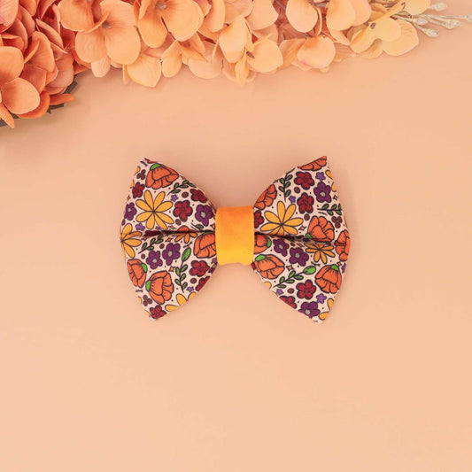 Golden Poppy puffy dog bow tie with orange, yellow, and purple floral print, handmade slide-on collar bow for dogs