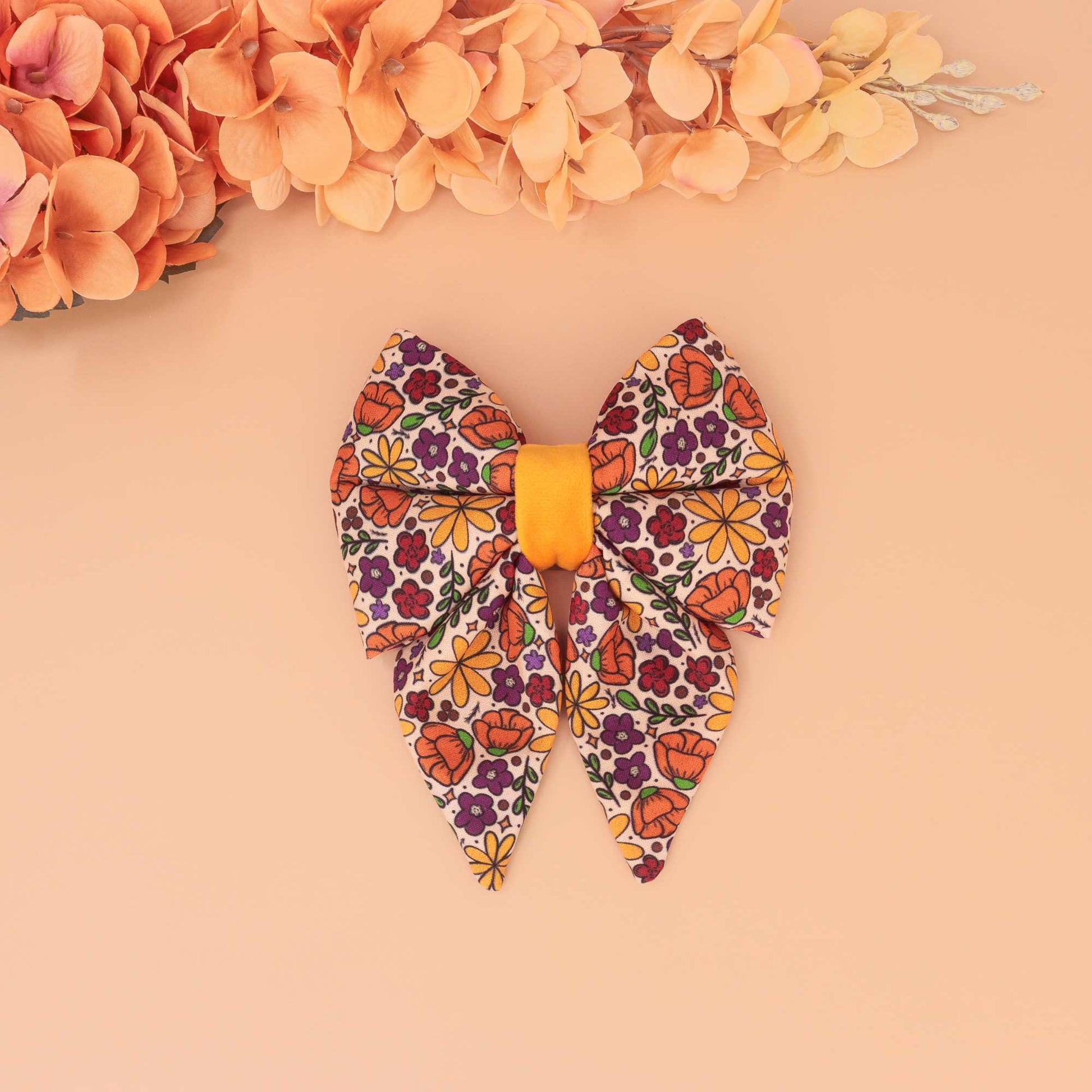 Golden Poppy dog sailor bow with orange, yellow, and purple floral print, handmade slide-on collar bow for autumn pets