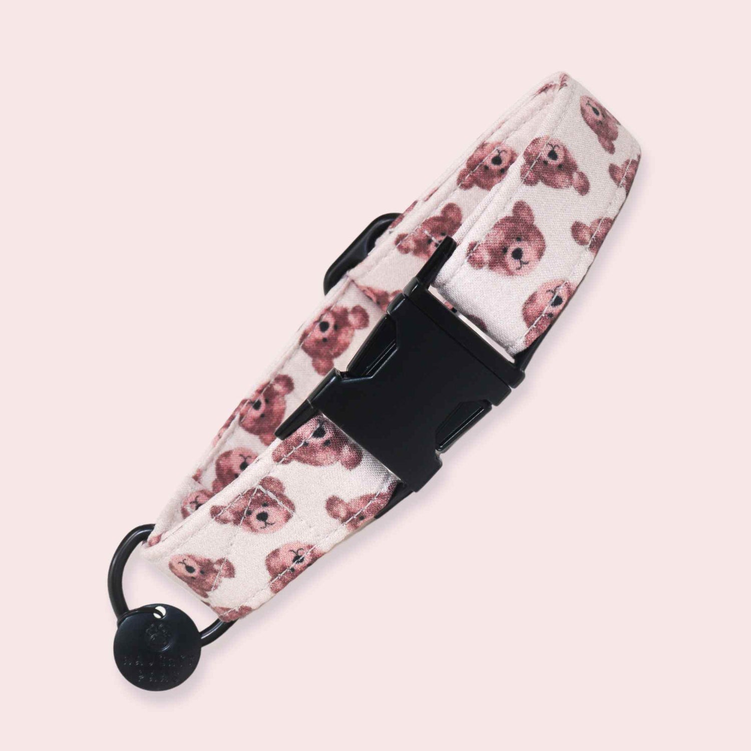 Dog collar featuring a teddy bear print in soft brown tones on a cream background with black hardware and an optional bell.