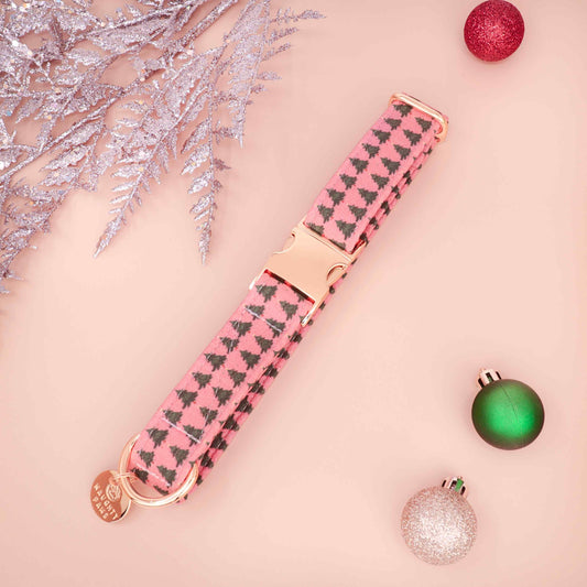 Pastel red Christmas dog collar with pine tree pattern on neutral background