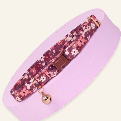 Floral breakaway cat collar featuring burgundy, blush pink, and cream wildflowers with rose gold hardware and optional bell.
