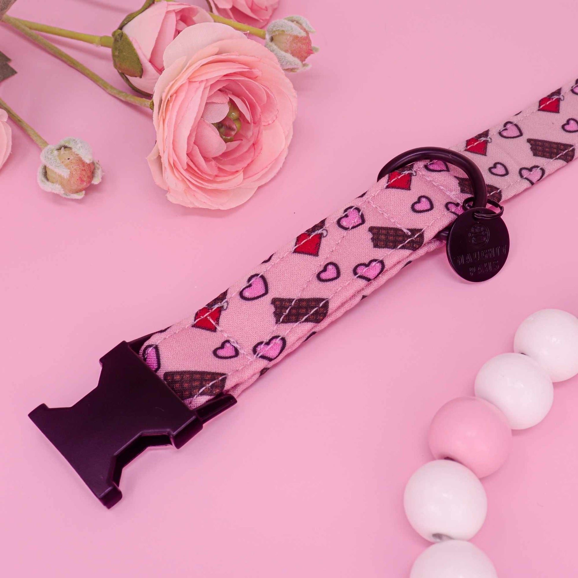 Handmade pink dog collar featuring chocolate bars and heart design
