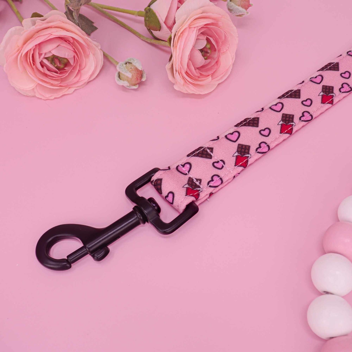 Handmade pink dog leash featuring chocolate bars and hearts

