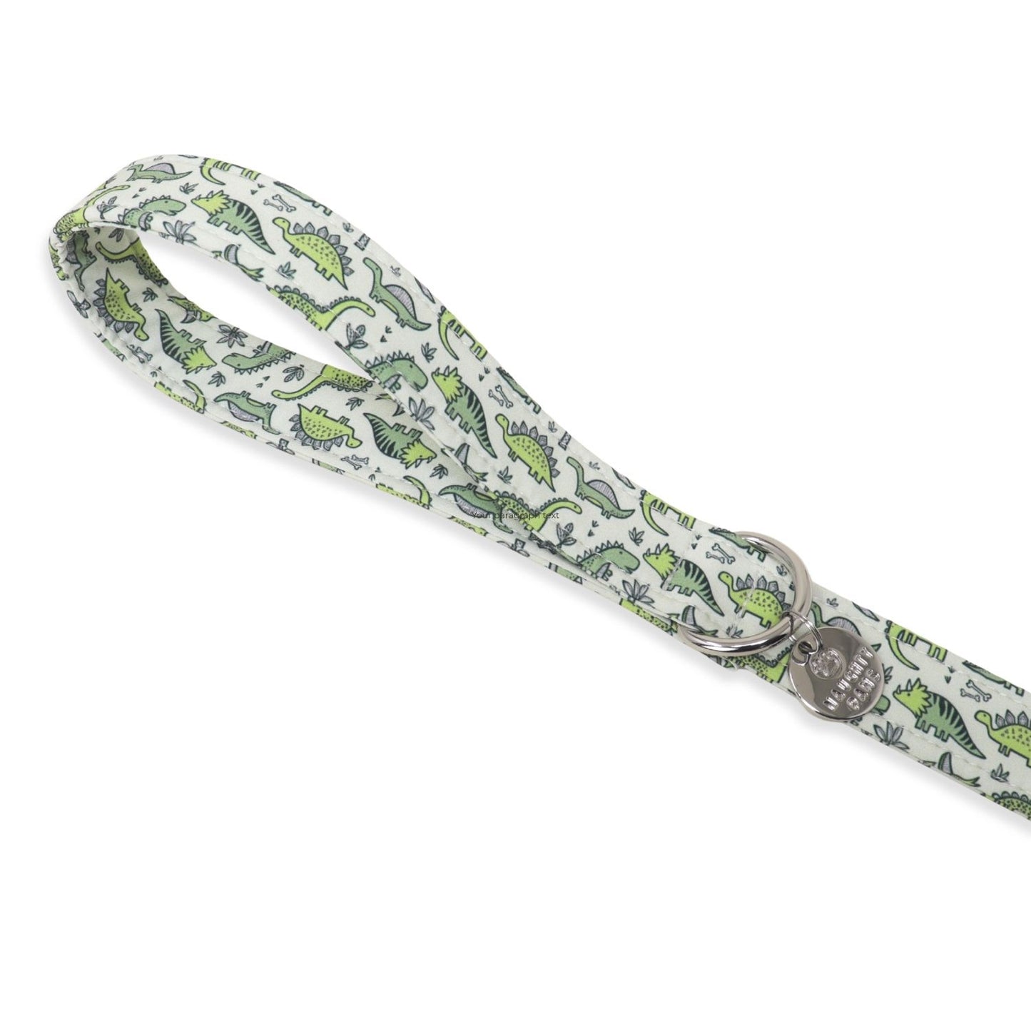 A fabric dog leash with a white background and a green dinosaur pattern, featuring a silver metal D-ring and a heart-shaped engraved tag that reads 'I LOVE MY LEASH'.