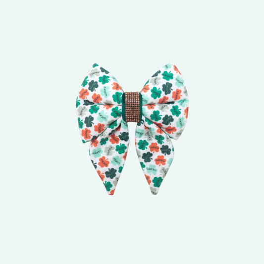 Lucky sailor dog bow with tails featuring clover print and lucky text, green St Patrick’s Day dog accessory