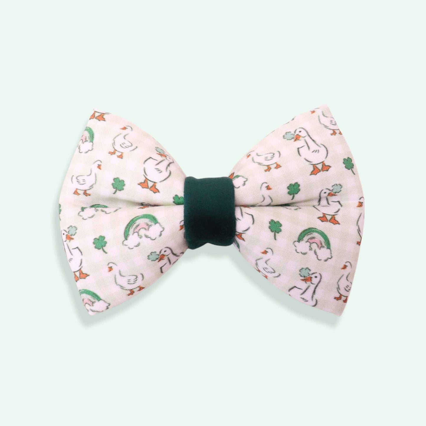 Bow tie with duck and leaf pattern on a light blue background