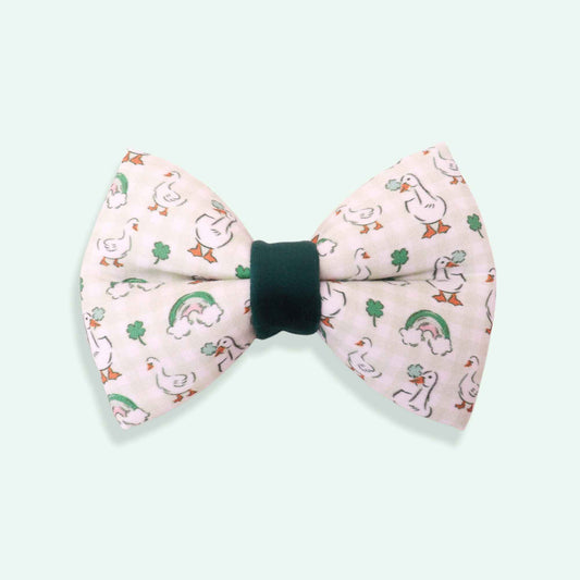 Bow tie with duck and leaf pattern on a light blue background