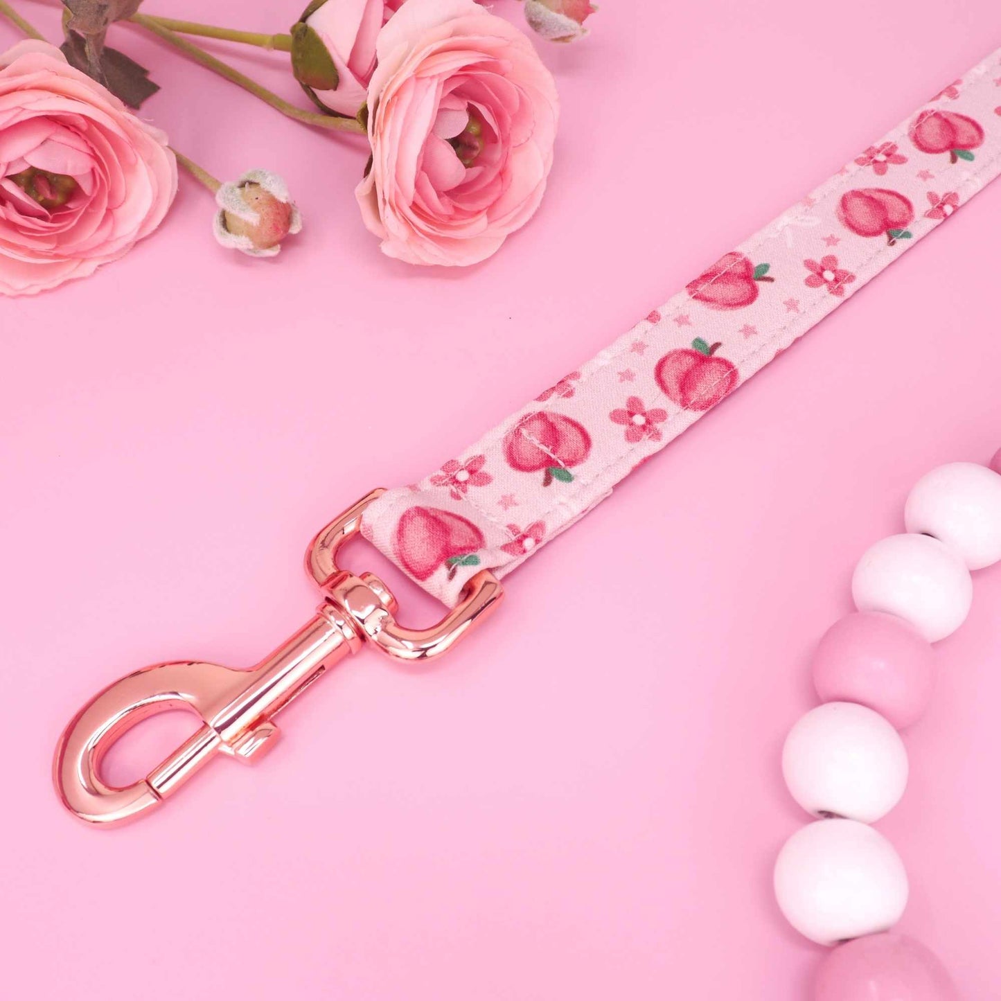 Handmade pink dog leash with peach print and metal hardware