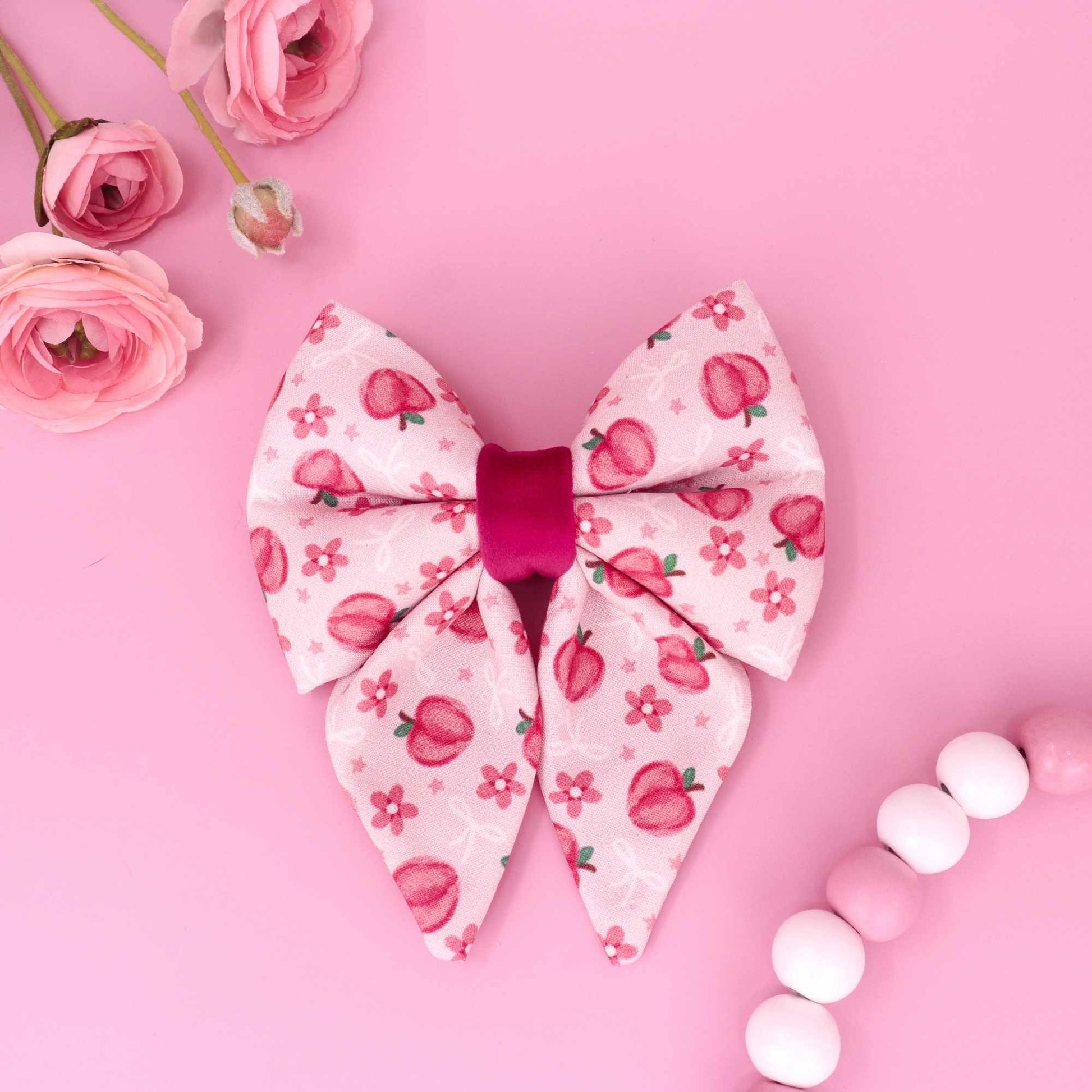 Sweet peach sailor dog bow with pink floral peach pattern
