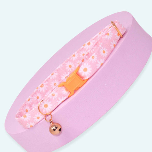 Pink breakaway cat collar with white daisy print, rose gold hardware, adjustable fit, and optional bell.