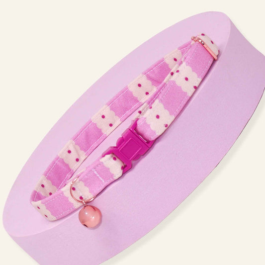 Pink scalloped breakaway cat collar with hot pink and light pink checker pattern, adjustable fit, rose gold hardware, and optional bell.
