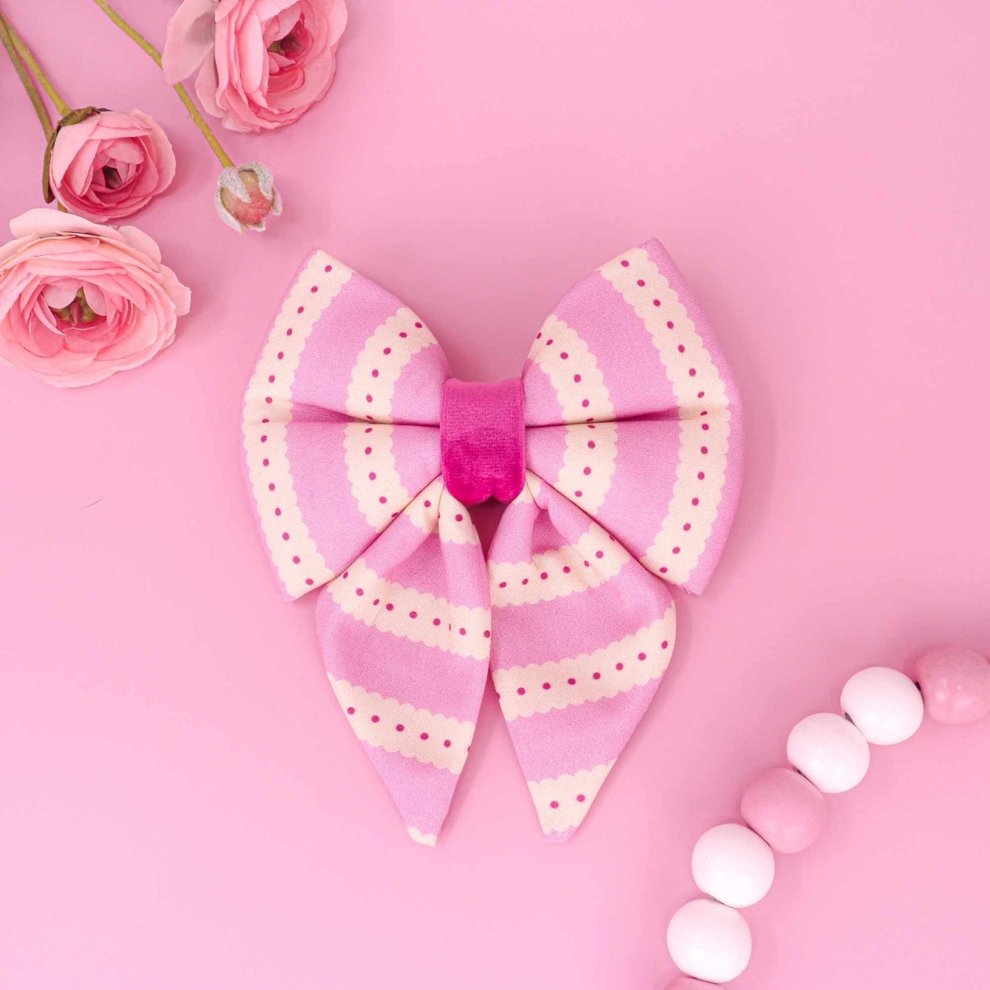 Handmade pink sailor dog sailor bow with scalloped pattern and coquette style.