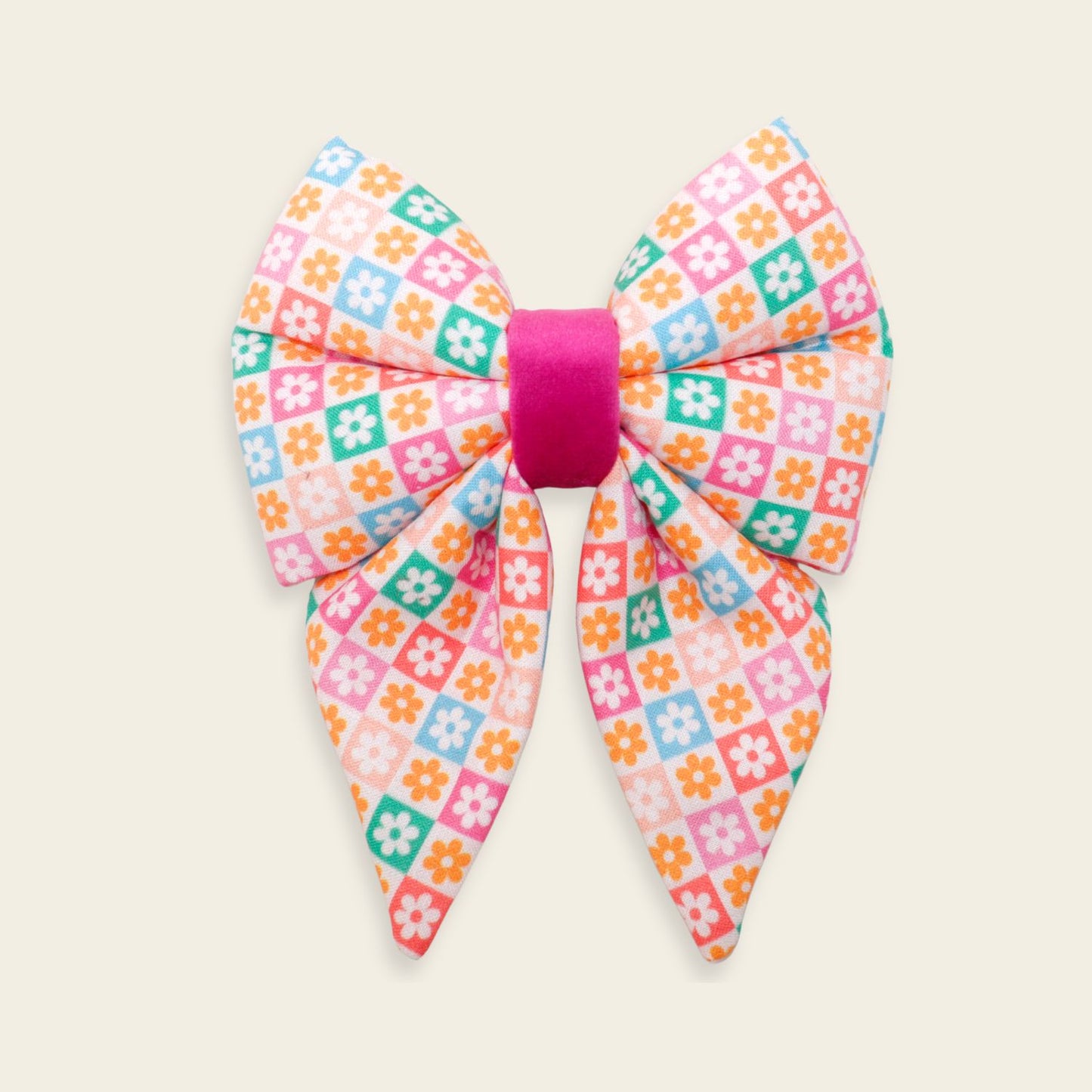 Handmade Retro Floral dog bow tie featuring colorful pastel daisy checkered fabric with a hot pink center, designed as an over-the-collar accessory for dogs.