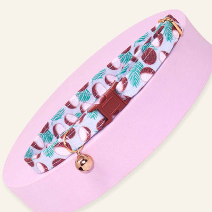 Tropical breakaway cat collar featuring coconuts, palm leaves, rose gold hardware, and a safety breakaway buckle.